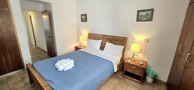 a bedroom with a bed with two towels on it at Retro art and mirrors Molos in Limassol
