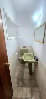 a bathroom with a green sink and a window at Retro art and mirrors Molos in Limassol