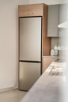 a stainless steel refrigerator in a kitchen at Central 2 bedroom flat in Nicosia