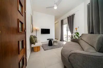 a living room with a couch and a tv at Central 2 bedroom flat in Nicosia