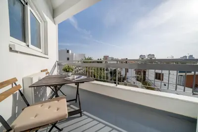 a balcony with a table and a view of the city at Central 2 bedroom flat in Nicosia