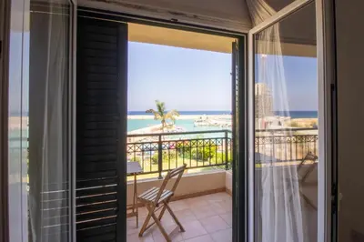 a room with a balcony with a view of the ocean at Frontline Sea-View Villa in Paralimni