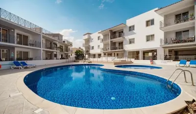 a swimming pool in front of some apartment buildings at Serenity Apartment with Pool in Paralimni
