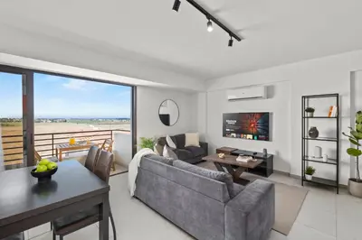a living room with a couch and a table at Aether Residence by Nomads in Tersephanou