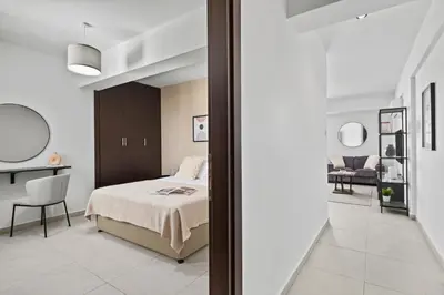 a bedroom with a bed and a desk and a chair at Aether Residence by Nomads in Tersephanou