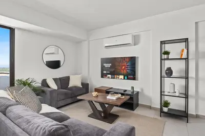 a living room with a couch and a table at Aether Residence by Nomads in Tersephanou