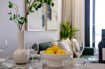 a table with a bowl of oranges and wine glasses at Artemis 304 - Seaside Stories in Livadhia