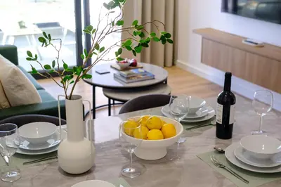 a table with a bowl of oranges and a bottle of wine at Artemis 304 - Seaside Stories in Livadhia