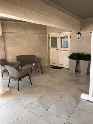 a patio with a table and a bench and a table at Sandy Nest Studio in Larnaka