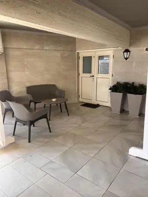 a patio with a table and a bench and a table at Sandy Nest Studio in Larnaka