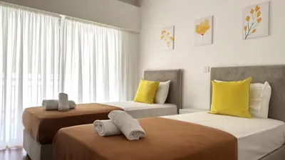a bedroom with two beds with towels on them at Modern 3BDR_Top Floor_Lux_Suite_Balcony in Limassol