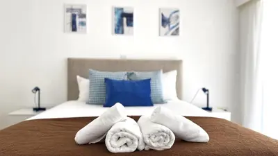 a bedroom with a bed with towels on it at Modern 3BDR_Top Floor_Lux_Suite_Balcony in Limassol