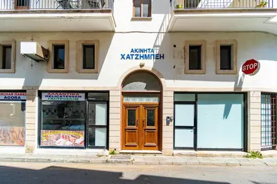 a building with a stop sign in front of it at Market View Apartment - Near The Beach in Larnaka