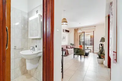 a bathroom with a sink and a toilet in a room at Market View Apartment - Near The Beach in Larnaka