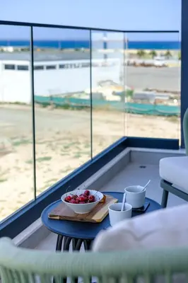 a bowl of fruit on a table in front of an airport at Artemis 205 - Seaside Stories in Livadhia