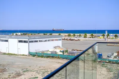 a building on the beach with the ocean in the background at Artemis 205 - Seaside Stories in Livadhia