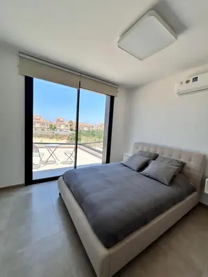 a bedroom with a large bed and a large window at Luxury Elegant Home in Protaras