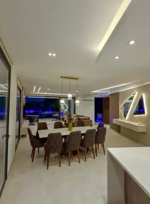 a dining room and living room with a table and chairs at Luxury Elegant Home in Protaras