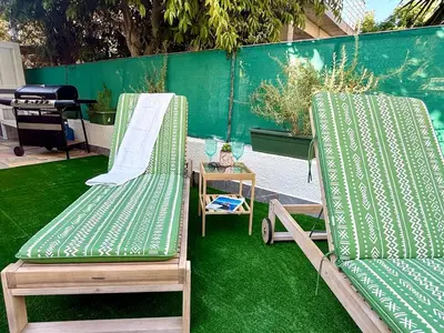 two lawn chairs and a table with a grill at Elegant Beach Villa Moonstone II in Meneou