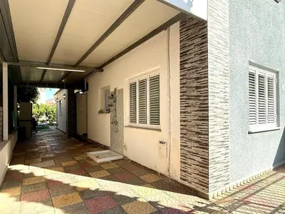 a hallway of a building with a door and a tile floor at Elegant Beach Villa Moonstone II in Meneou