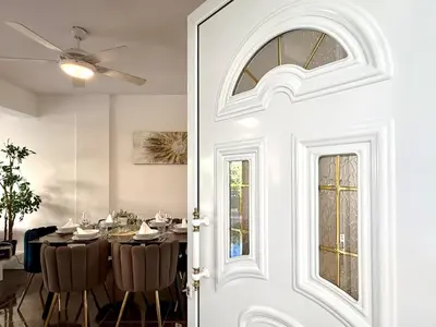 a dining room with a table and a white door at Elegant Beach Villa Moonstone II in Meneou