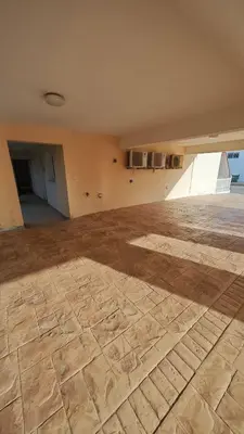 an empty room with a wooden floor in a building at Nissi 87 Apartment - Luxcyservices in Ayia Napa