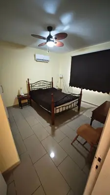 a bedroom with a bed and a ceiling fan at Nissi 87 Apartment - Luxcyservices in Ayia Napa