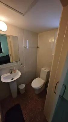 a bathroom with a toilet and a sink and a mirror at Nissi 87 Apartment - Luxcyservices in Ayia Napa