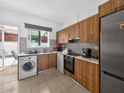 a kitchen with a washer and dryer at Villa Rena - 3BR Retreat near Kalamies Beach in Paralimni