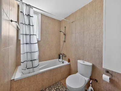 a bathroom with a toilet and a bath tub at Villa Rena - 3BR Retreat near Kalamies Beach in Paralimni