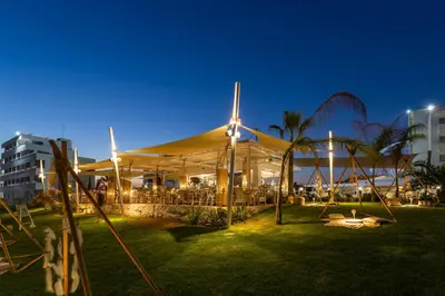 a large white tent with tables and chairs at night at Piere - Anne Beach Hotel in Ayia Napa
