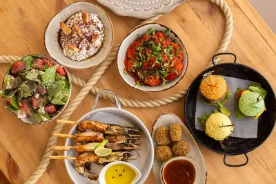 a wooden table with plates of food on it at Piere - Anne Beach Hotel in Ayia Napa