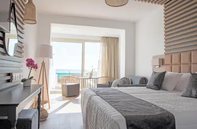 a bedroom with a bed and a view of the ocean at Piere - Anne Beach Hotel in Ayia Napa