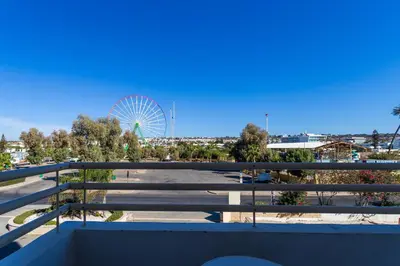 a view of a parking lot with a ferris wheel at Piere - Anne Beach Hotel in Ayia Napa