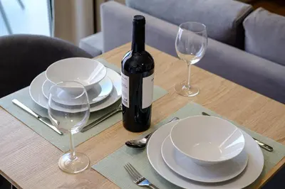 a table with a bottle of wine and two glasses at Artemis 106 - Seaside Stories in Livadhia