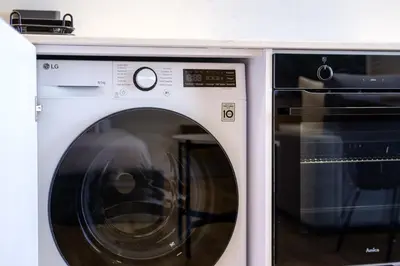 a white washing machine sitting next to a microwave at Artemis 106 - Seaside Stories in Livadhia