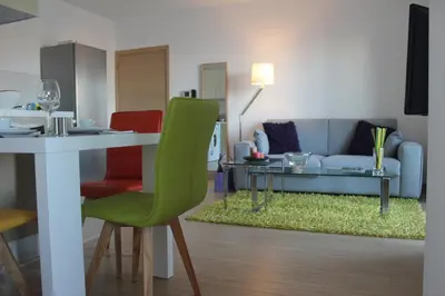 a living room with a table and a couch at Eden Beach Apartment 611 in Limassol