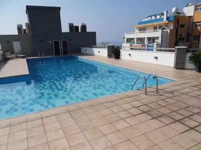 a swimming pool on the roof of a building at Eden Beach Apartment 611 in Limassol