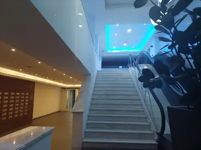 a staircase in a building with a green light at Eden Beach Apartment 611 in Limassol