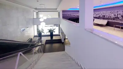 a staircase in a building with a view of a city at Eden Beach Apartment 611 in Limassol
