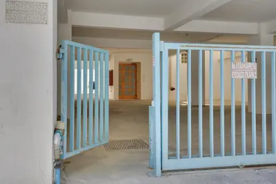 an open gate in a room with a red door at Penthouse Central Larnaca The 'Veranda' Elena Court in Larnaka