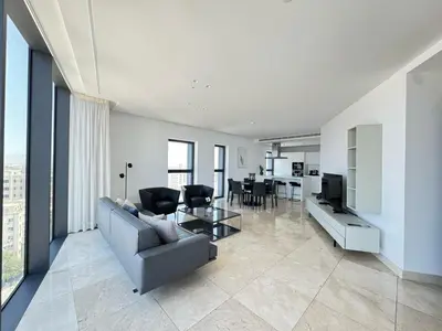 a living room with a couch and a table at SkyHigh Park View Residence in Nicosia