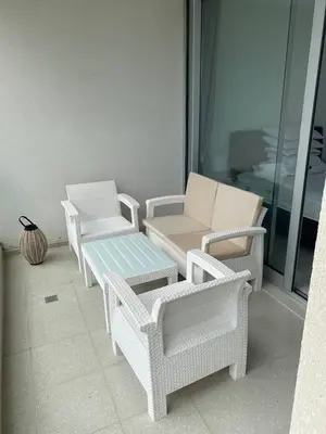 four white wicker chairs and a bench on a balcony at Northern Cyprus Iskele Bogaz Abelia One plus One Sea View in Boğaz