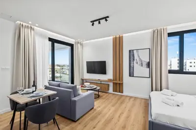 a living room with a couch and a table at Artemis 206 - Seaside Stories in Livadhia