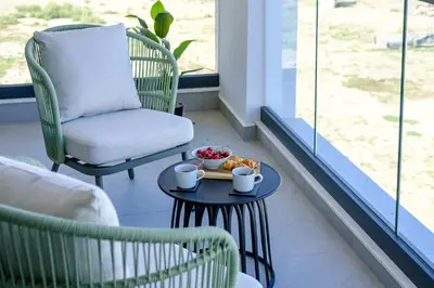a room with a chair and a table with food on it at Artemis 206 - Seaside Stories in Livadhia