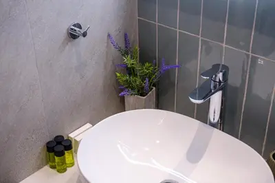 a bathroom with a white toilet and a sink at Artemis 206 - Seaside Stories in Livadhia