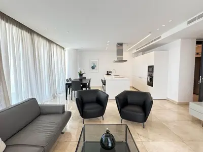 a living room with a couch and chairs and a table at SkyHigh Park View Living in Nicosia