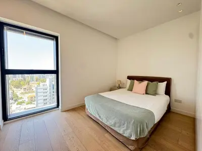 a bedroom with a bed and a large window at SkyHigh Park View Living in Nicosia