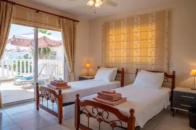 two beds in a bedroom with a balcony at Golden Sands No10 in Ayia Napa