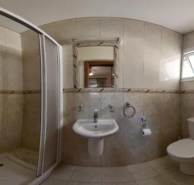 a bathroom with a sink and a shower and a toilet at Golden Sands No10 in Ayia Napa